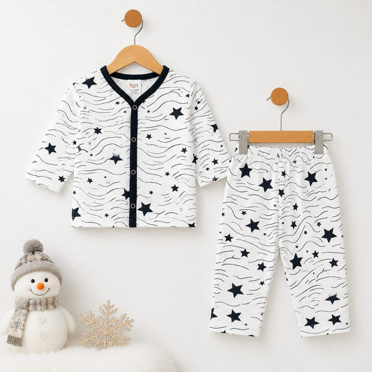 A baby two-piece outfit set consisting of a long-sleeve cardigan and matching pants, displayed on wooden hangers against a white wall. The set features a white base with black wavy lines and scattered black stars, with a black trim along the front button 