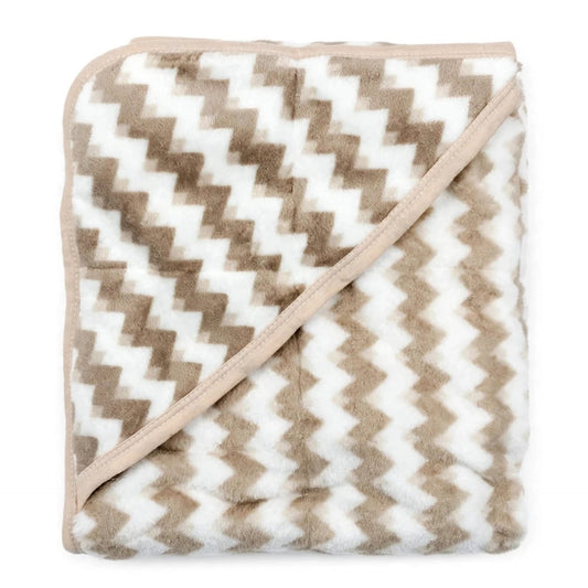 A folded plush throw blanket featuring a beige and white chevron pattern with a solid beige border and matching diagonal edge trim, shown against a plain white background.