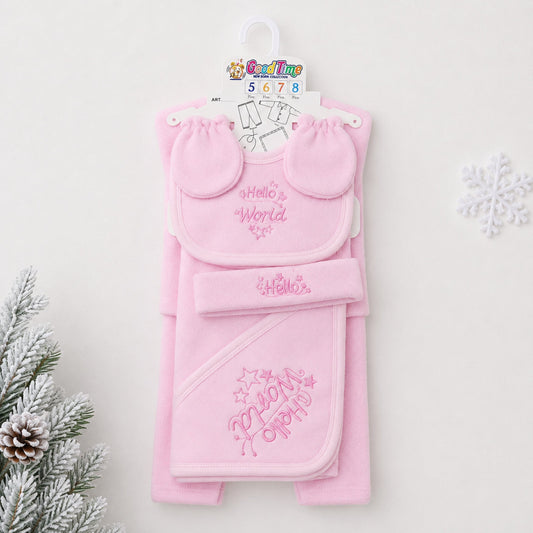 A pink baby gift set hanging on a white hanger against a light background, featuring a bib with 'Hello World' embroidery, a matching hat, and a hooded towel with 'My First Party' embroidery. Decorative pine branches and a snowflake are visible at the edge