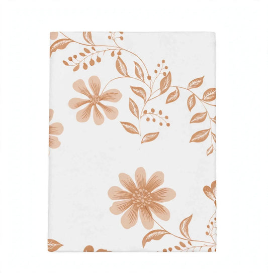 A rectangular white fabric item, likely a tea towel or napkin, featuring a dusty rose and terracotta floral pattern on a clean white background.