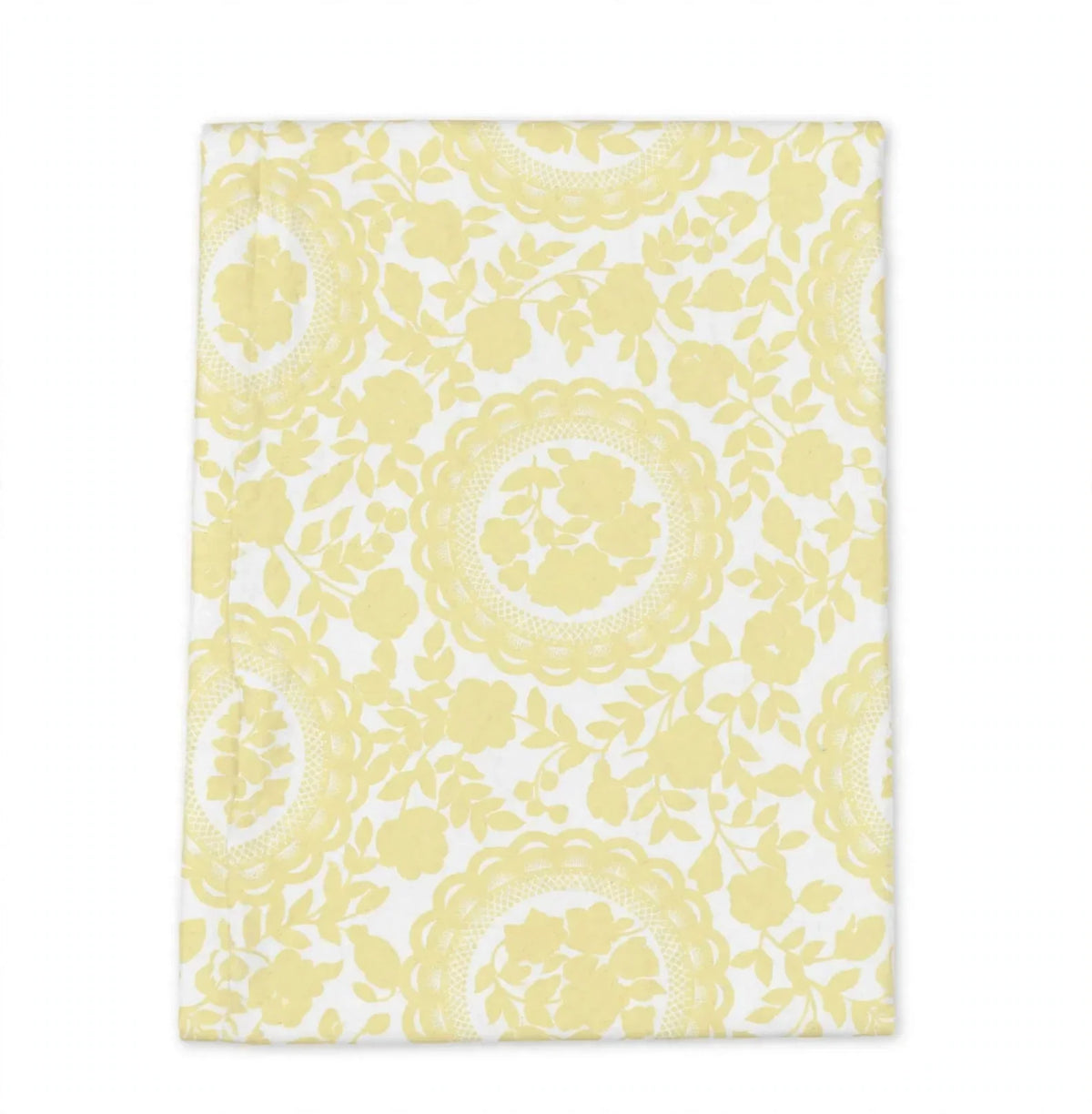 A rectangular white fabric item, likely a tea towel or napkin, featuring a repeating light yellow floral and circular lace-like pattern, shown flat against a white background.
